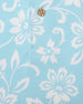 Men's Napali Coast Polo in Gemstone, close-up fabric detail view featuring an allover white Hawaiian floral and vine print on a light aqua blue performance fabric with a natural wood-tone button