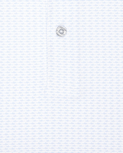 Close-up of white golf polo with light blue shark print and button detail