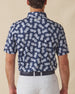 Men's Pineapple Express Polo in New Indigo, back view on model showcasing the navy and white pineapple print with Straight Down logo at the back collar, styled with light grey pants