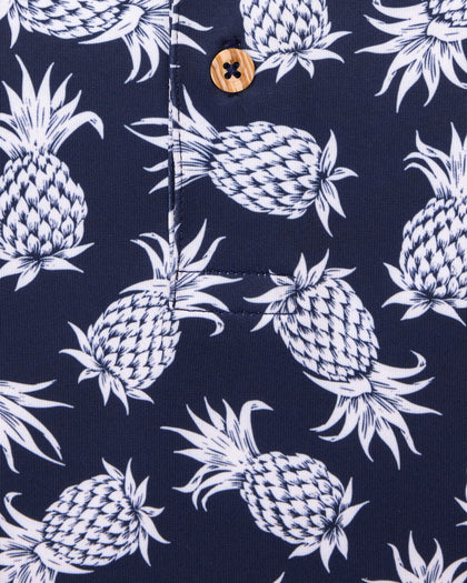 Men's Pineapple Express Polo in New Indigo, close-up detail view of the navy and white pineapple print with wood button
