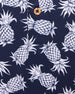 Men's Pineapple Express Polo in New Indigo, close-up detail view of the navy and white pineapple print with wood button