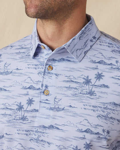 Men's Outrigger Polo in Powder, close-up detail view of the wood button placket and collar featuring the light blue Hawaiian scenic print