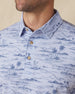 Men's Outrigger Polo in Powder, close-up detail view of the wood button placket and collar featuring the light blue Hawaiian scenic print