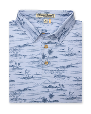 Men's Outrigger Polo in Powder, folded flat lay front view featuring a light blue Hawaiian toile print with palm trees, waves, and outrigger canoes with wood buttons