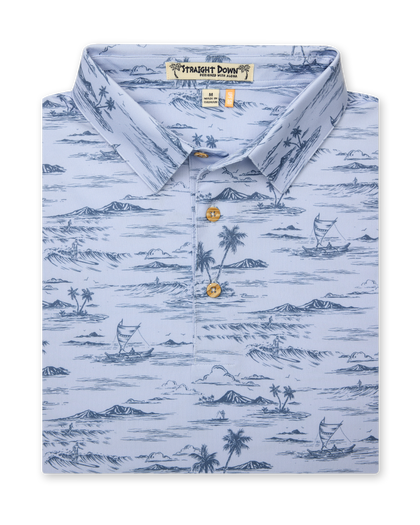 Men's Outrigger Polo in Powder, folded flat lay front view featuring a light blue Hawaiian toile print with palm trees, waves, and outrigger canoes with wood buttons
