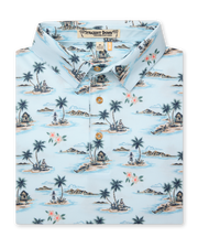 Men's Land Of Aloha Polo in Sea Spray, folded flat lay front view featuring a light blue short sleeve polo with an allover Hawaiian island scene print with palm trees, thatched huts, hula dancers, outrigger canoes, and hibiscus flowers, with a Straight Down Designed with natural wood-tone buttons