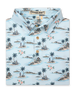 Men's Land Of Aloha Polo in Sea Spray, folded flat lay front view featuring a light blue short sleeve polo with an allover Hawaiian island scene print with palm trees, thatched huts, hula dancers, outrigger canoes, and hibiscus flowers, with a Straight Down Designed with natural wood-tone buttons