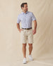 Men’s printed golf polo with beige shorts and white sneakers, styled in a casual warm-weather outfit