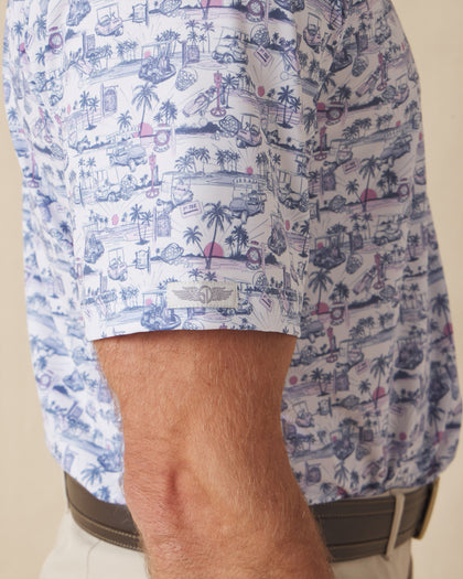 Close-up of short sleeve showing tropical golf print and logo tab detail