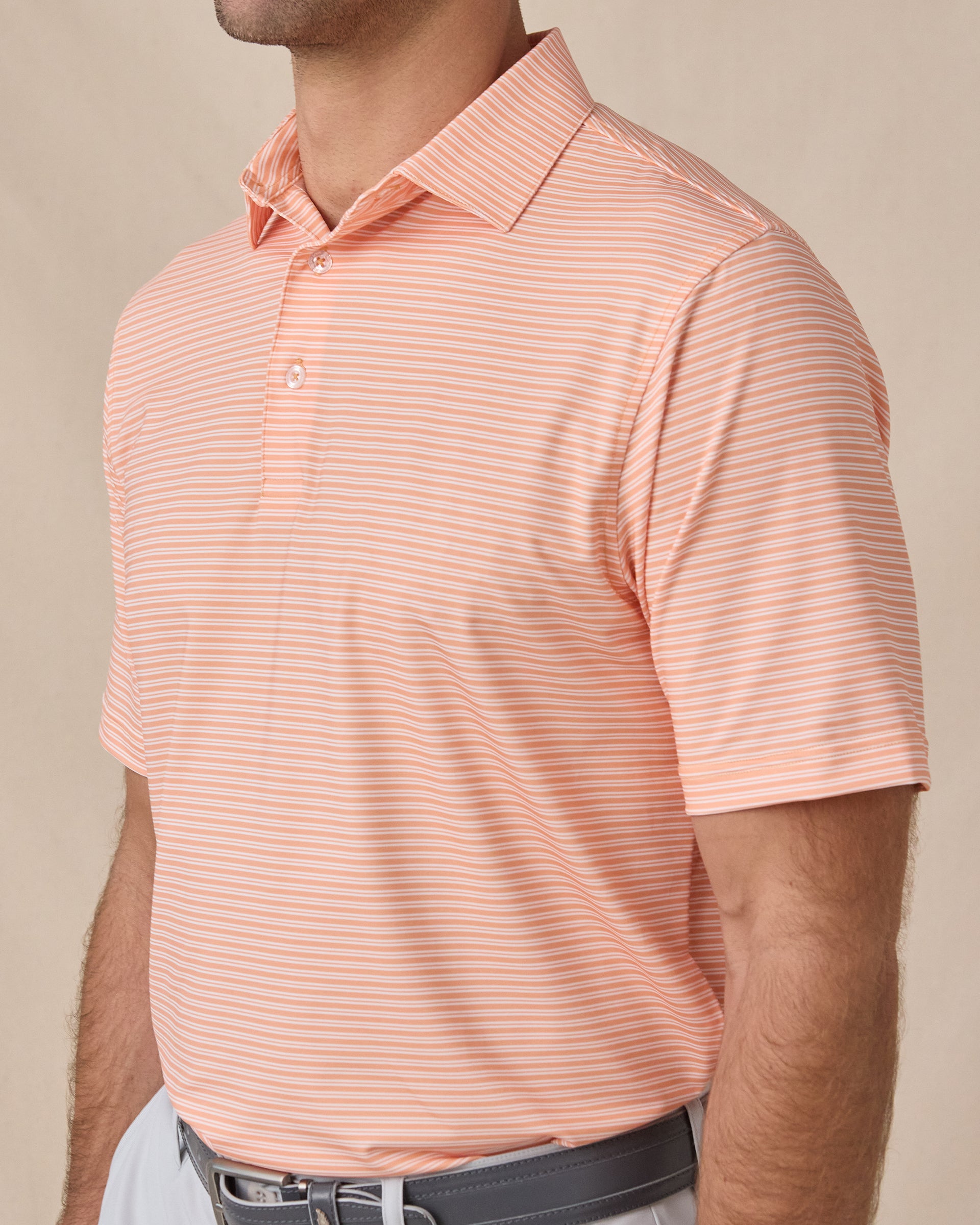 Close-up of the Campus Stripe Polo in Cantaloupe highlighting the fine white stripe pattern, collar, and button placket.