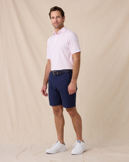 Model styled in the Campus Stripe Polo in lilac paired with navy shorts and white sneakers