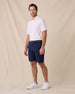 Model styled in the Campus Stripe Polo in lilac paired with navy shorts and white sneakers