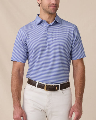 Model wearing the Campus Stripe Polo in Tidal Blue with light-colored pants, showcasing the classic striped design