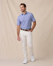 Model styled in the Campus Stripe Polo in Tidal Blue paired with light pants and white sneakers