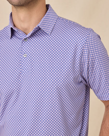 Close-up of the Ironwood Polo in tidal blue highlighting the structured collar, branded buttons, and geometric print pattern