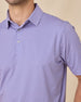 Close-up of the Ironwood Polo in tidal blue highlighting the structured collar, branded buttons, and geometric print pattern