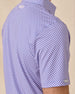 Close-up side view of the Ironwood Polo in tidal blue showing the geometric pattern and sleeve logo tab detail