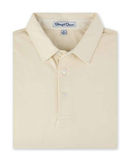 Close-up of the Oxford Polo in Summer Sand, featuring a classic collar, two-button placket, and subtle textured fabric.