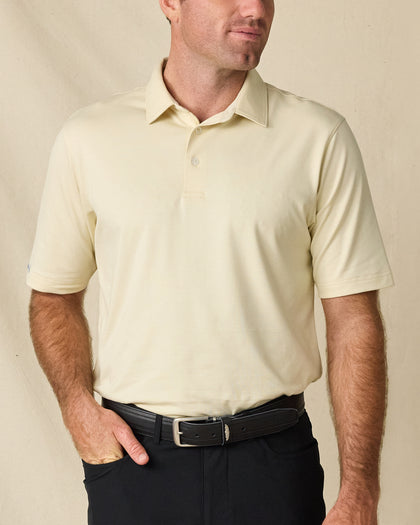 Front view of a man wearing the Summer Sand Oxford Polo tucked into black pants with a black leather belt.