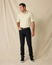 Man modeling the Oxford Polo in Summer Sand with black pants, a black belt, and black sneakers.