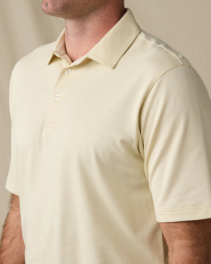 Close-up of the Summer Sand Oxford Polo showing its classic collar, two-button placket, and textured knit fabric.