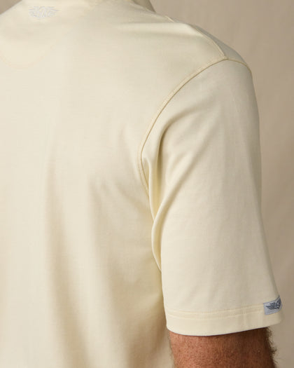 Close-up of the Oxford Polo in Summer Sand, highlighting the shoulder stitching, textured fabric, and Straight Down logo tab on the sleeve.