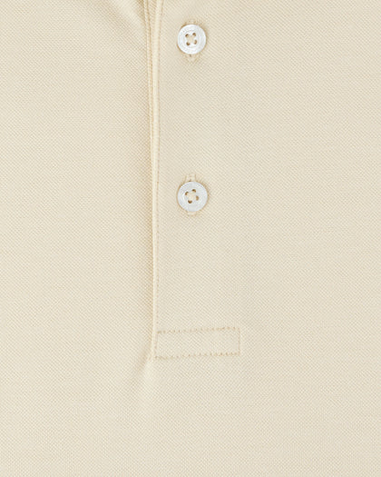 Close-up of the Oxford Polo in Summer Sand, showcasing the textured fabric, two Straight Down branded buttons, and reinforced placket stitching.