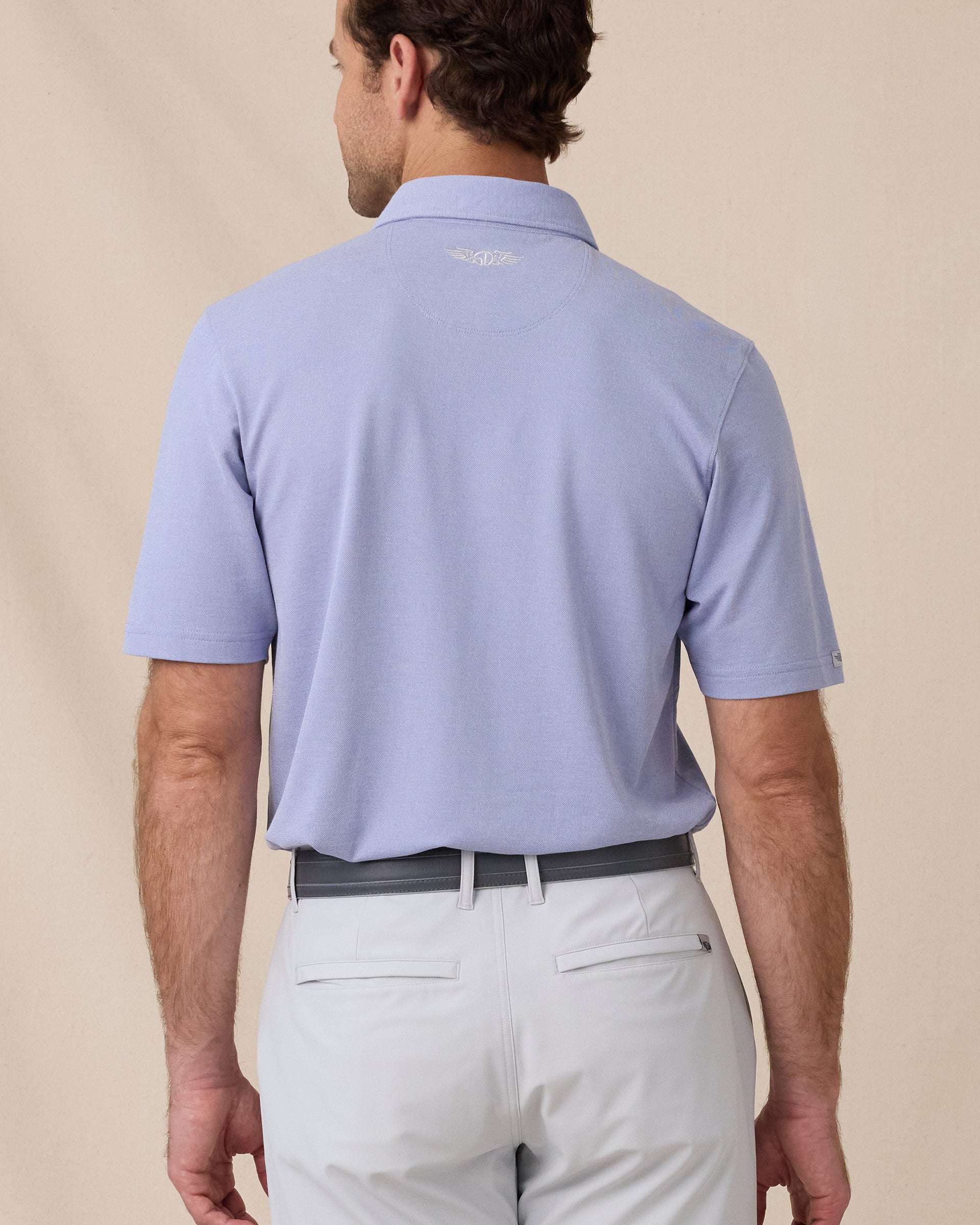 Back view of the Oxford Polo in chambray blue featuring a clean silhouette and embroidered Straight Down logo at the neck