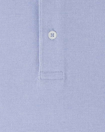 Close-up of Oxford Polo fabric in chambray blue showing textured knit construction and button placket detail