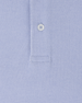 Close-up of Oxford Polo fabric in chambray blue showing textured knit construction and button placket detail
