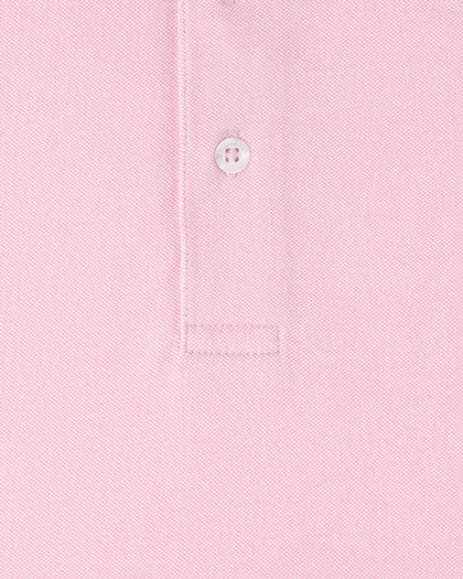 Close-up of Oxford Polo fabric in punch pink showing textured knit construction and button placket detail