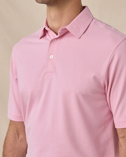 Close-up side view of the Oxford Polo in punch pink highlighting the textured knit fabric and tailored fit
