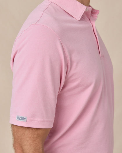 Sleeve tag detail of the Oxford Polo in punch pink