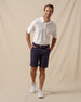 Oxford Polo in White, full outfit model view styled with navy shorts