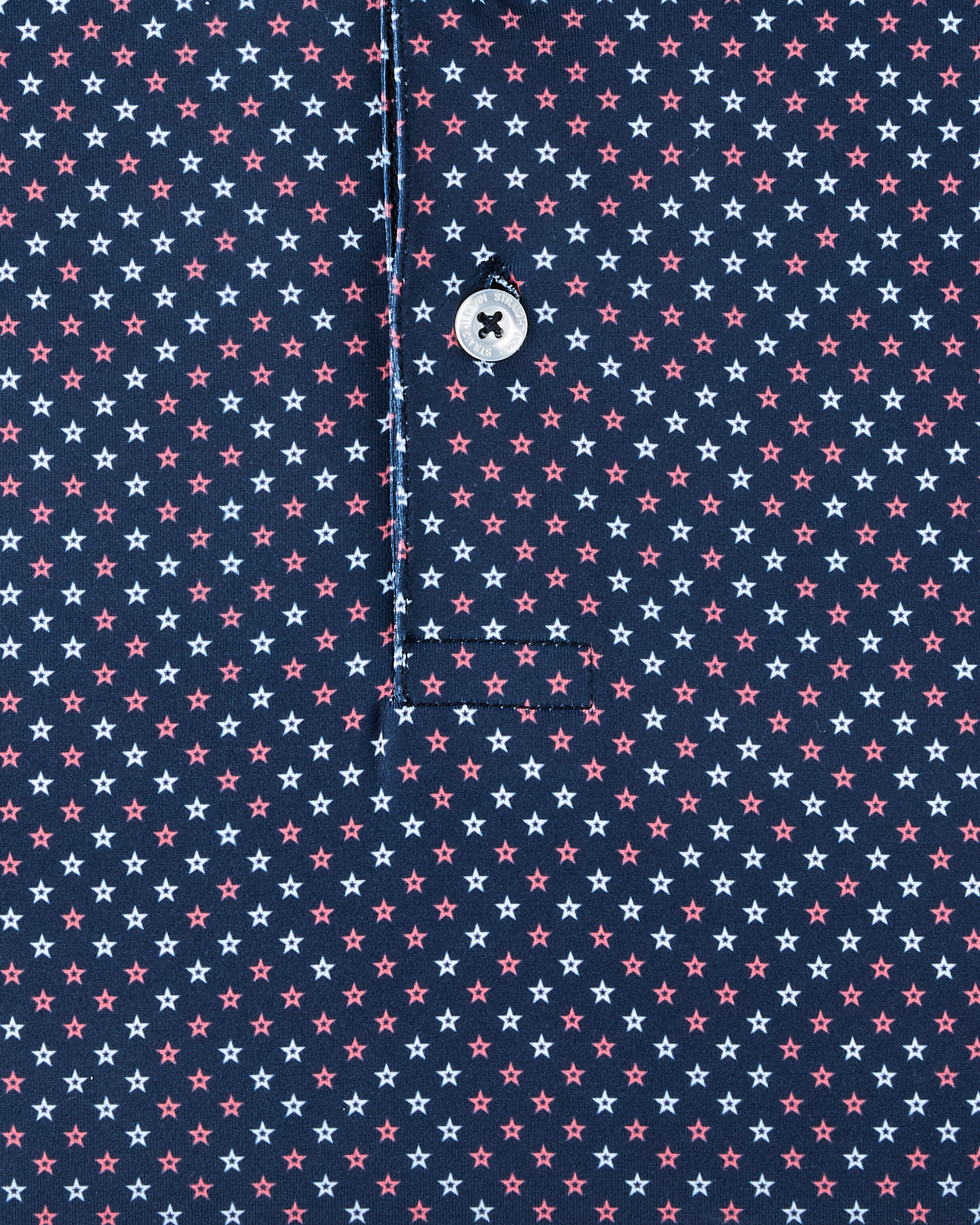Close-up detail of the Star Struck Polo in New Indigo showing red and white, star pattern on performance fabric