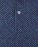 Close-up detail of the Star Struck Polo in New Indigo showing red and white, star pattern on performance fabric