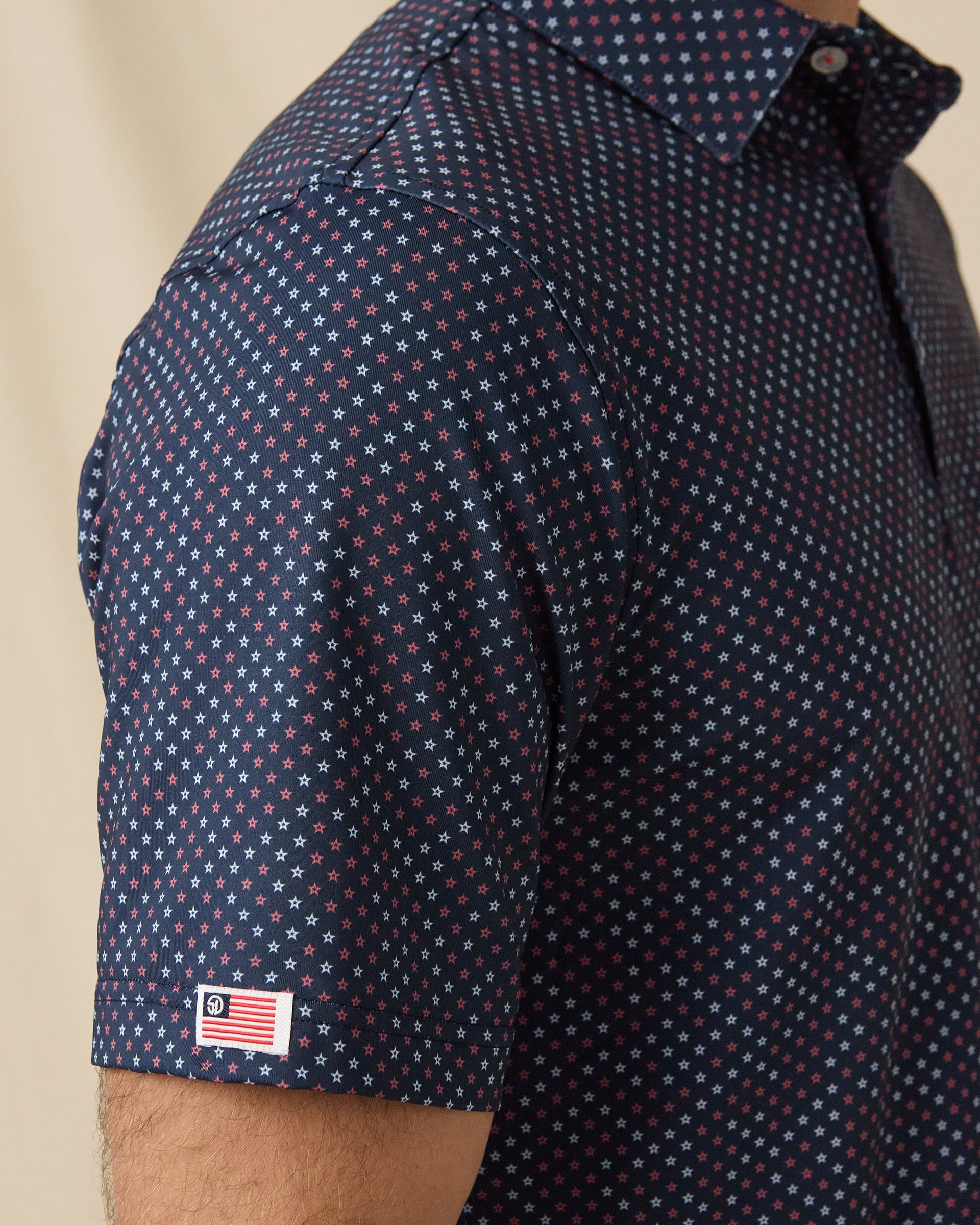 Star Struck Polo in New Indigo with sleeve flag logo detail close-up