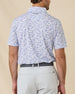 Back view of the Waterman Polo in Tidal Blue featuring a continuous tropical tile pattern