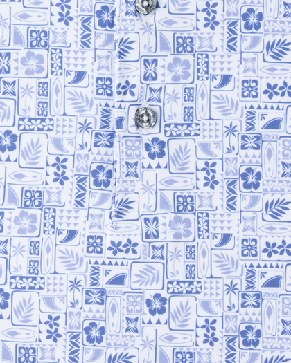Close-up of the Waterman Polo in Tidal Blue featuring an intricate tile pattern with tropical florals, palm fronds, and surf-inspired details