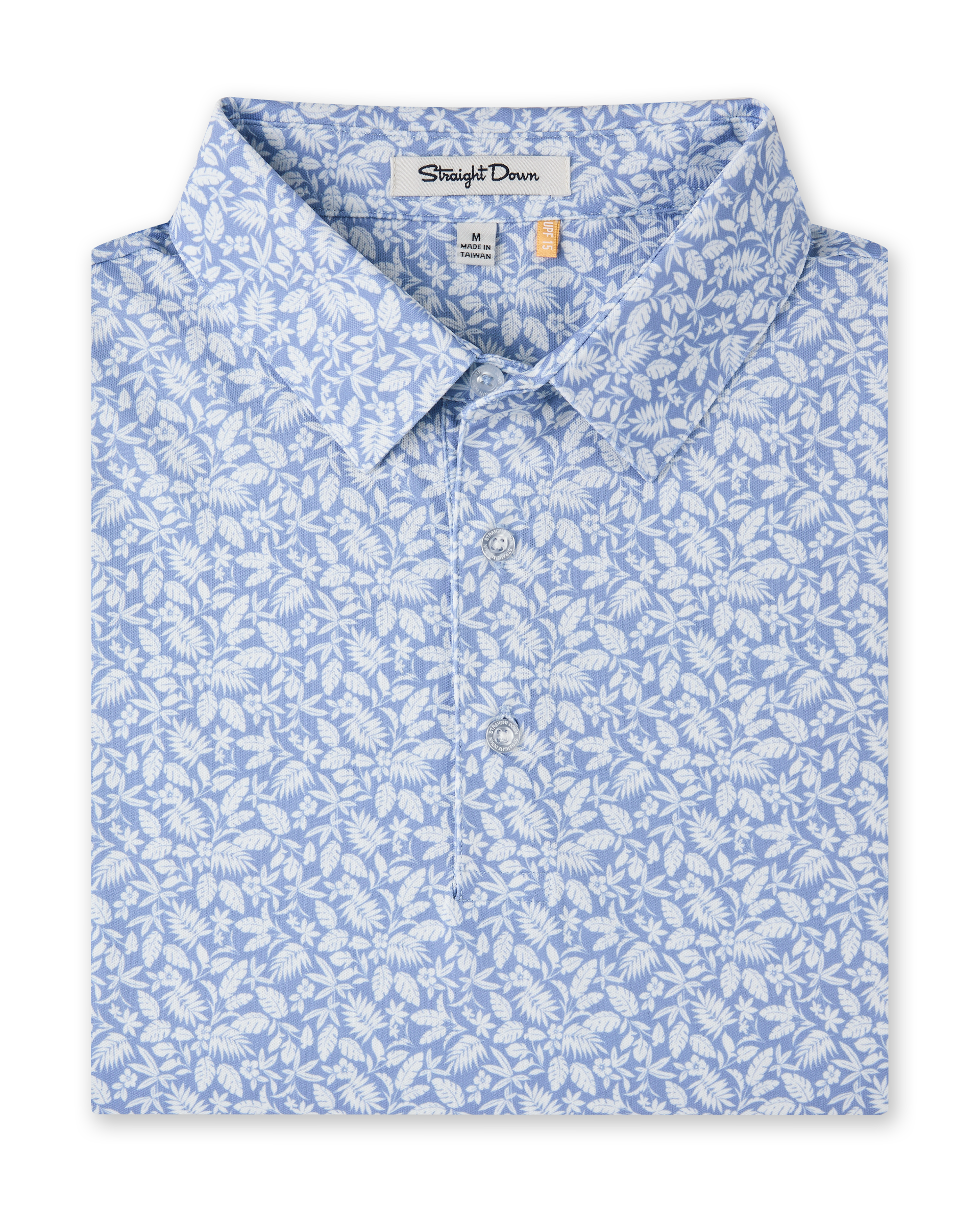 Close-up product view of the Tropics Lounge Polo in Blue Shade, featuring an allover white botanical print on a light blue background and a three-button placket.