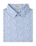 Close-up product view of the Tropics Lounge Polo in Blue Shade, featuring an allover white botanical print on a light blue background and a three-button placket.