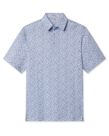 Front product view of the Tropics Lounge Polo in Blue Shade, featuring short sleeves, a classic polo collar, and an allover white botanical print.
