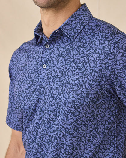 Close-up chest view of the Tropics Lounge Polo in Tidal Blue showcasing the intricate tropical print