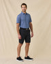 Model wearing the Sarasota Polo in Moonlight with dark shorts, a black belt, and black sneakers.