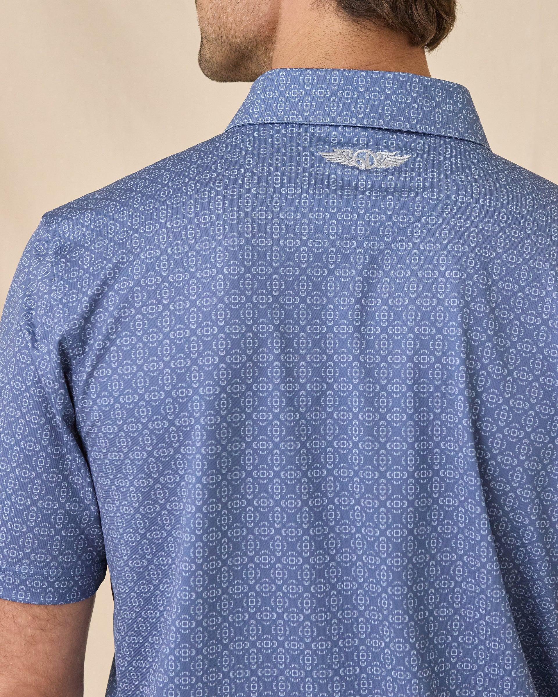 Close-up of the Sarasota Polo in Moonlight showing the all-over print and embroidered logo below the collar.