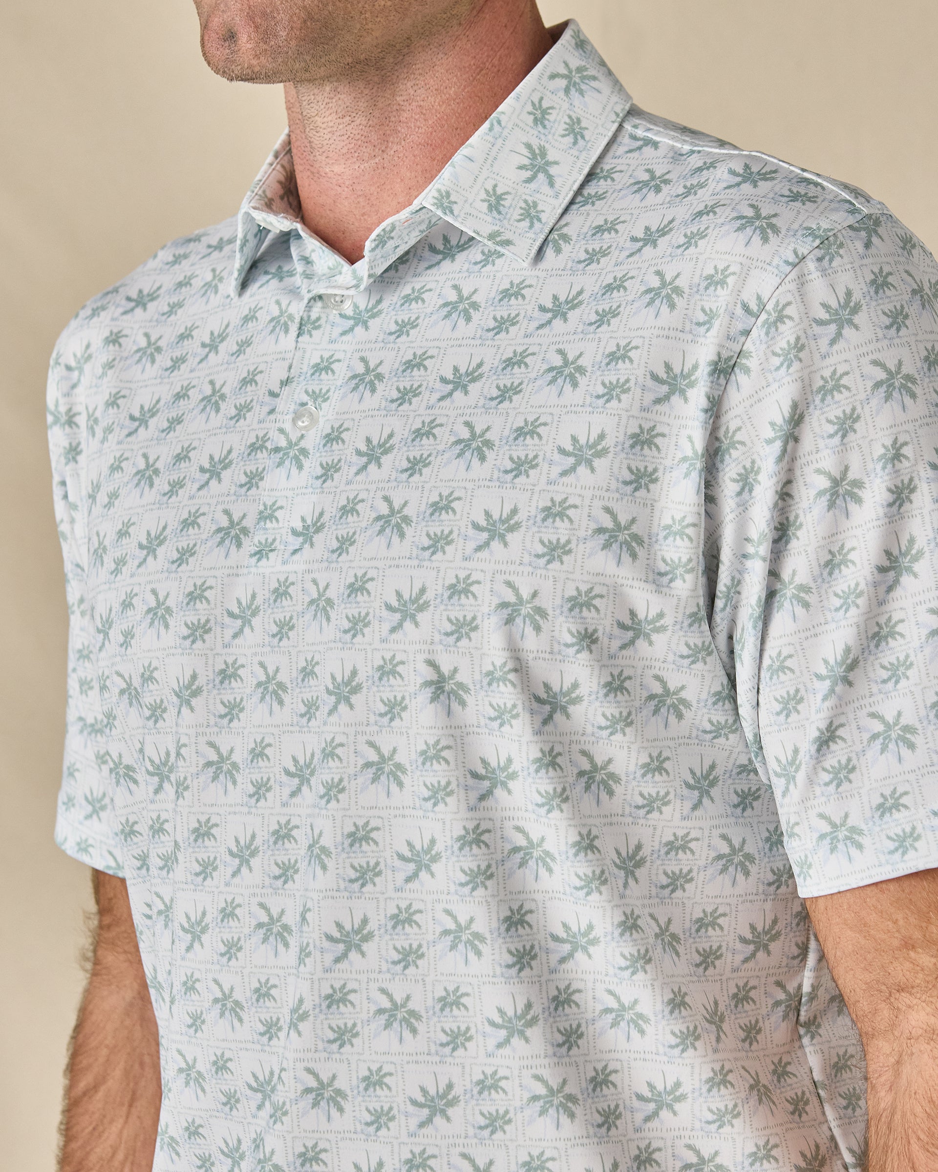 Close-up of the 29 Palms Polo in Herb, highlighting the tonal palm tree print and classic polo collar.