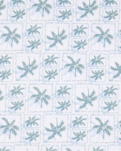 Close-up of the 29 Palms Polo in Herb showing the repeating light green palm tree print arranged in a subtle grid pattern.