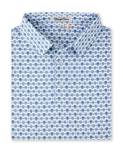 Day of the Dead Polo in Herb featuring an all-over blue and green sugar skull print with a classic polo collar and button placket.