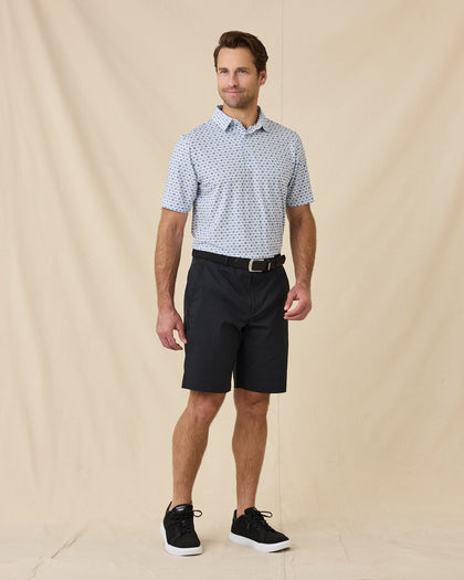 Model wearing the Day of the Dead Polo in Herb with black shorts and black golf shoes.