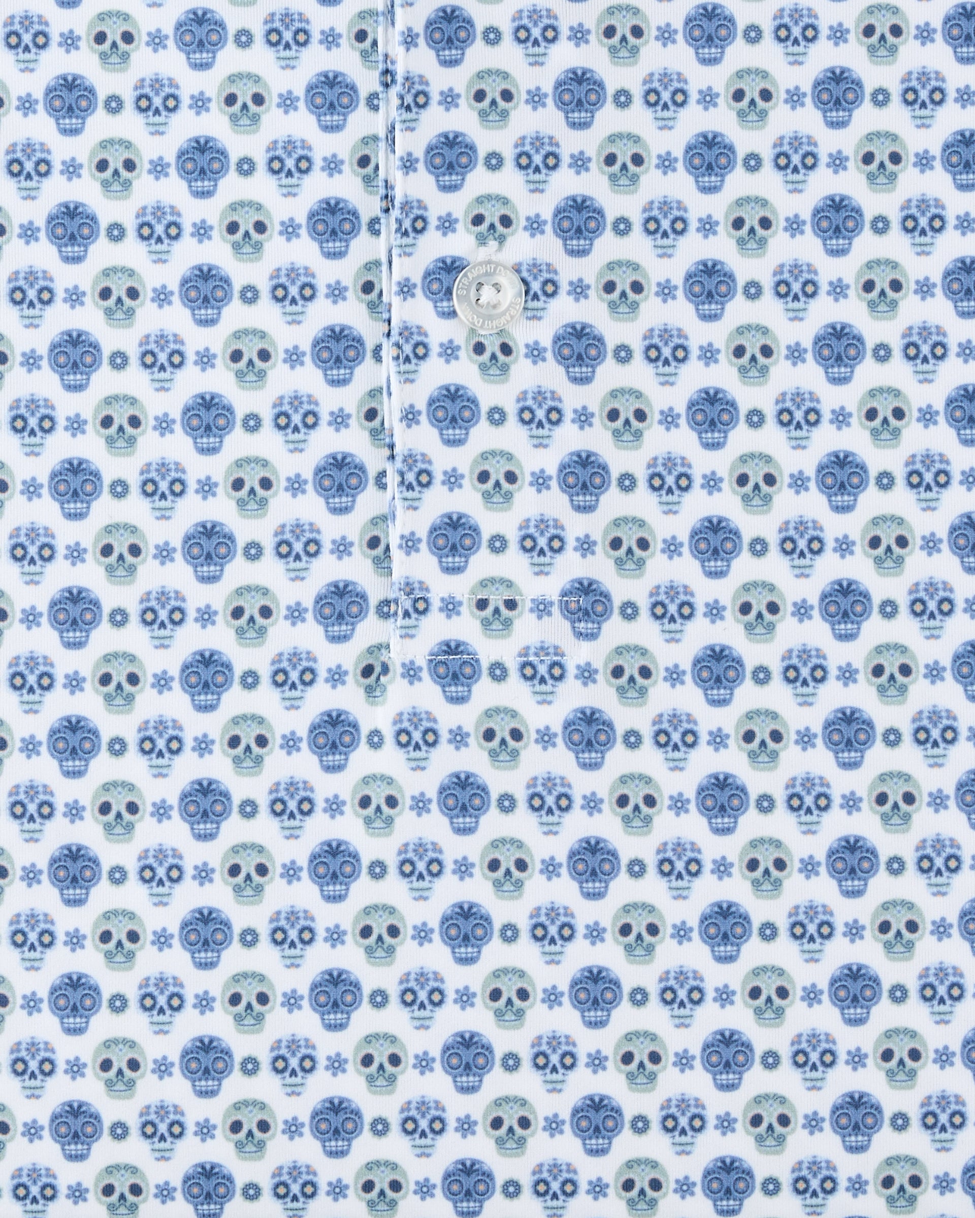 Close-up of the Day of the Dead Polo fabric highlighting the repeating blue and green sugar skull pattern.
